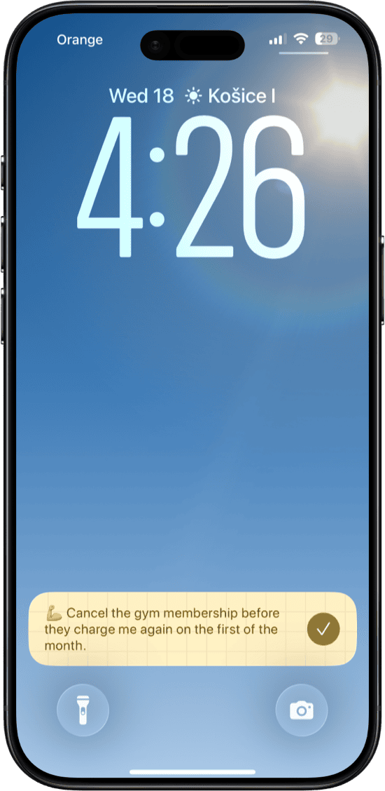 iPhone lock screen showing a Whisper Memos reminder notification